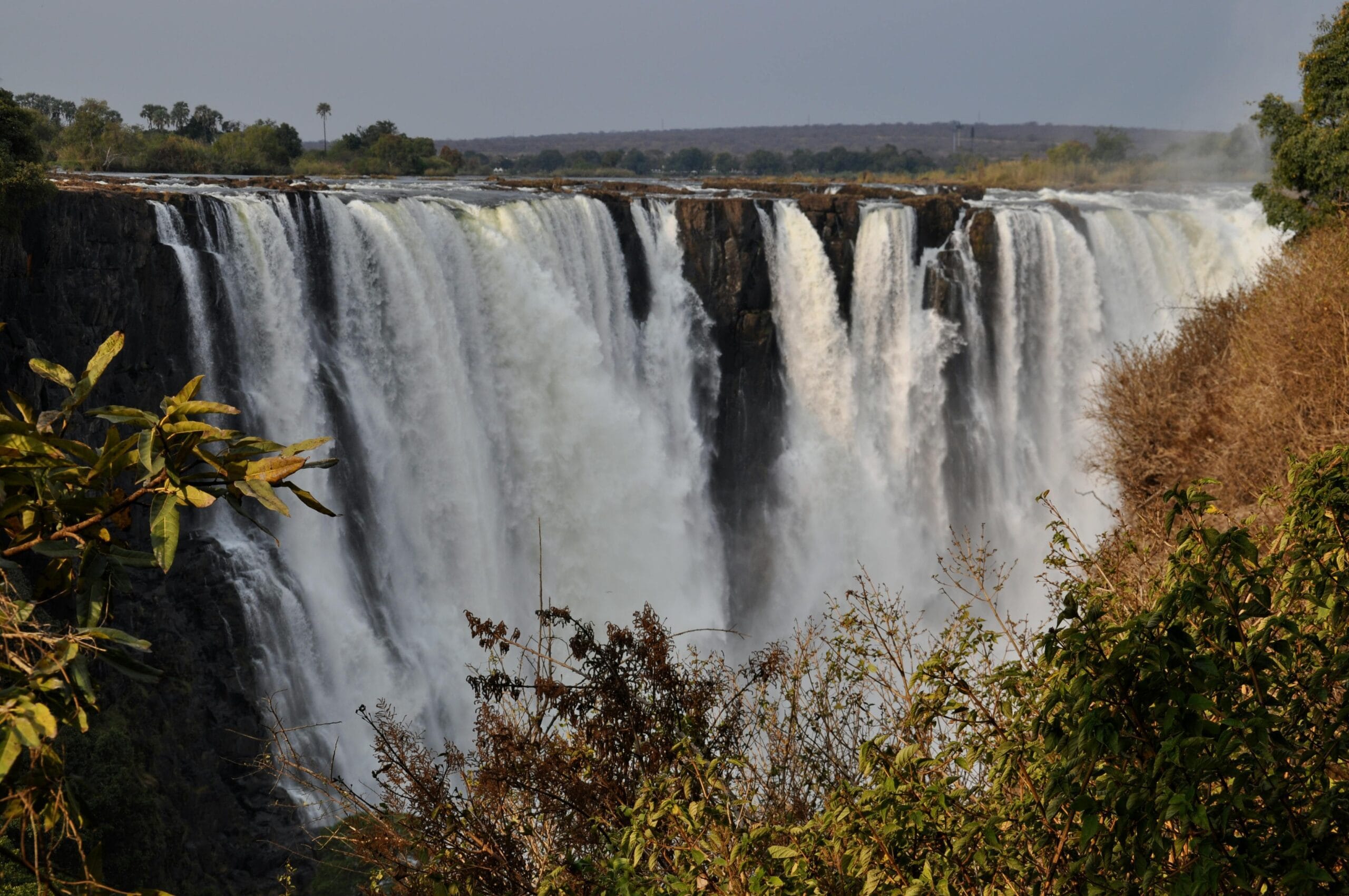 Spectacular view of Victoria Falls cascading in Zimbabwe, showcasing natural beauty and power.