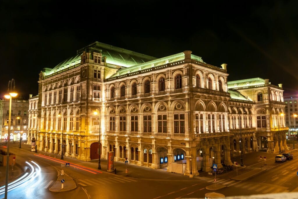 Stunning night view of the illuminated Vienna State Opera House, a famous Austrian landmark.